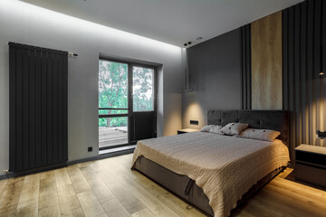 Naklejka na ściany i meble Modern and loft bedroom with dark and grey style. Dark headboard and wooden floor with glass window