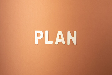 white wooden letters blueprint on brown background