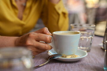 Woman holding morning cup of coffee.