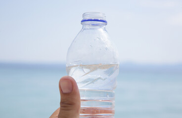Plastic water bottle with blue sky and sea background