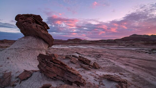 Colorful sunset timelapse in the Mars area of the Utah desert looking past hoodoo.
