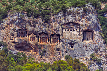 Famous rock-cut Lycian grave tombs of kings in carved caves in the cliffs of ancient Caunos (Kaunos) town, a UNESCO world heritage site at Dalyan, Mugla, Turkey.
