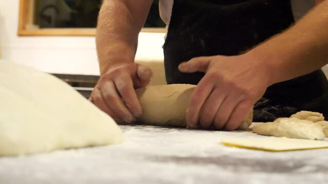 Chef prepares and shape a loaf of bread 