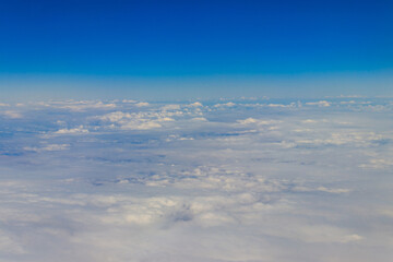 Fototapeta premium Beautiful white clouds in blue sky. View from airplane