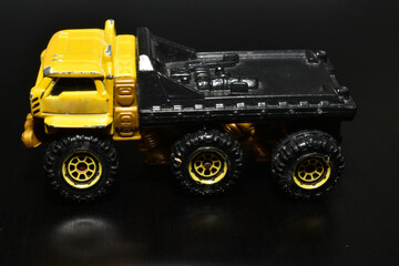 Big truck with yellow cab on black.