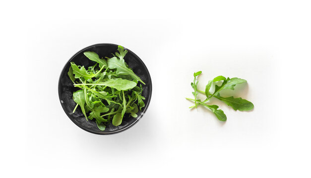 fresh rucola leaves isolated on white top view