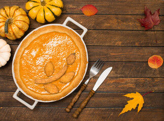Thanksgiving background with homemade pumpkin pie top view.