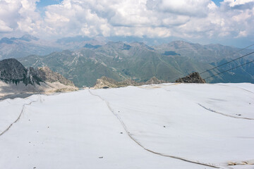 The alpine ice is being protected from global warming. Presena glacier in northern Italy protected from the sun with huge reflective tarps. - 521080963