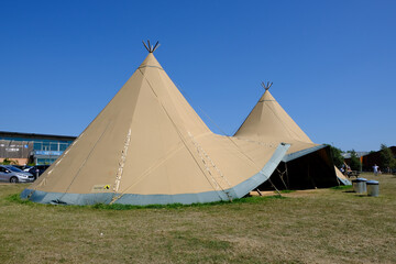 A large Nordic Teepee tent is setup for people to use and enjoy as a picnic spot © Ambrosiniv