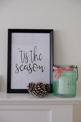Christmas decorations, with a poster with the phrase Tis the Season