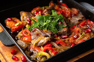 Stewed lamb with vegetables in a frying pan. With selective focus