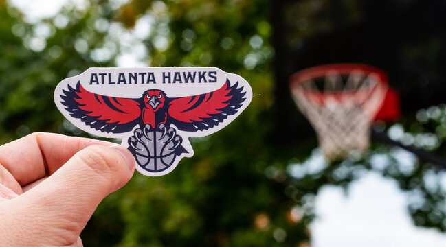 September 15, 2021, Atlanta, USA, A Man Holds The Emblem Of The Basketball Club Atlanta Hawks In His Hand On The Sports Field.