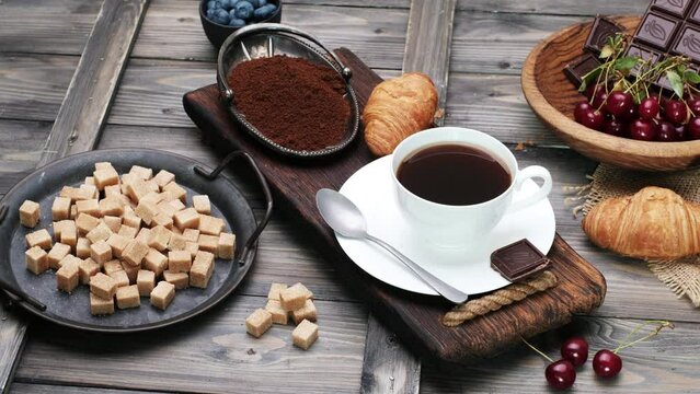 Coffe, chocolate and brown sugar. Close-up 4k video shooting, dark background.