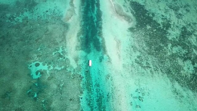 Aerial footage of a boat sailing inside a German channel made by Germans in Palau during ww2. Snorkeling Koror. National park in Palau. Visiting marine lakes in Chelbacheb