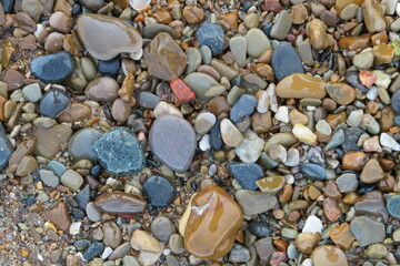 smooth wet rocks on beach sand