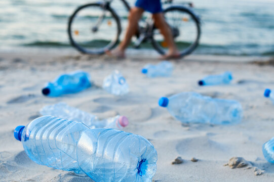 Plastic bottles on sea beach. Environmental pollution by plastic waste