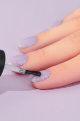 Womans hand with fashionable lavender manicure. Spring summer nail design