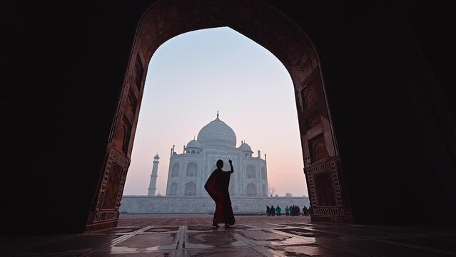 Silhouette woman in saree Indian dress costume dancing in Taj Mahal India