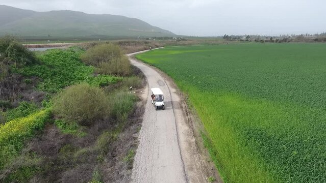 Small touring car driving in north israel landscape, aerial

Drone view from Valley of the Beit Shean springs, 2022
