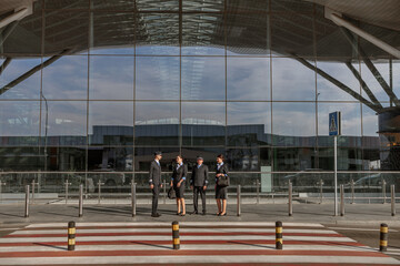 Flight team standing outdoor with terminal on the background
