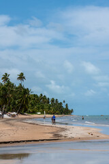 Brazil, Alagoas, 2021, january 21st - A long beach with tourists enjoying a summer day in northeast Brazil