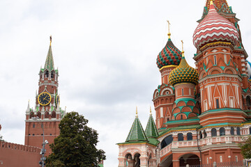 Fototapeta na wymiar Moscow Kremlin in Russia, Spasskaya Tower and St. Basils Cathedral