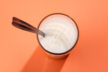 Fototapeta na wymiar Powdered milk mix in the glass with water