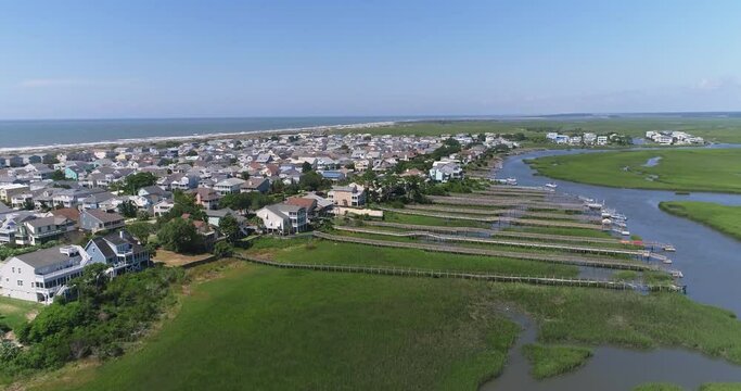 Drone shot of houses along the Intercoastal Waterway with Bird Island Wildlife Sanctuary off in the distance