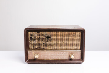 Antique radio receiver on white table, white background. Clipping path