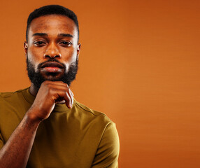 young pretty african american man posing cheerful on brown background, lifestyle people concept