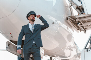 Male aircraft pilot standing outdoors at airport © Friends Stock