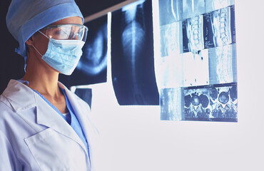 Image of attractive woman doctor looking at x-ray results.