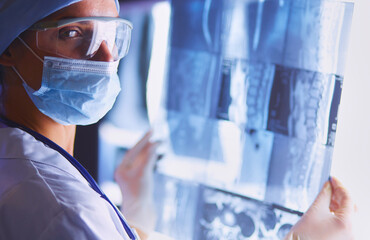 Two female women medical doctors looking at x-rays in a hospital.