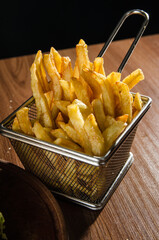 the photograph shows some french fries on a metal rack