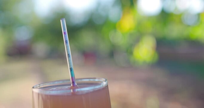 Winegrower placing hydrometer in glass cup for a test of grape juice. Checking alcohol of wine with wine alcohol meter.