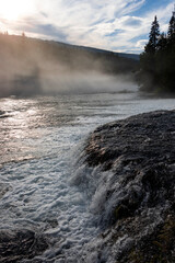 mist coming off moving river at dusk