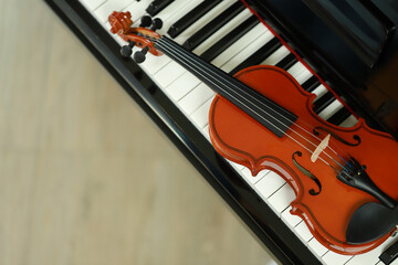 high angle photo Violin on the piano