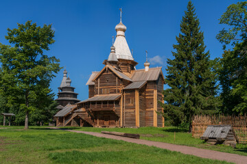 View of the Church of the Assumption of the Virgin and the Church of St. Nicholas in the Novgorod Museum of Folk Wooden Architecture of Vitoslavlitsa on a sunny summer day, Veliky Novgorod, Russia