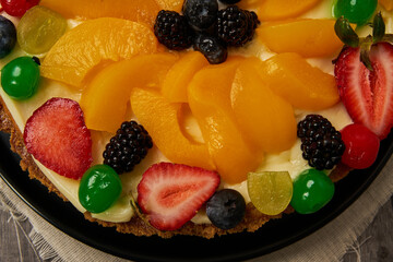 fruitcake with strawberries, blueberries, cherries and peaches, top view