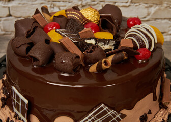 chocolate cake with cherry and peach chocolate decorations, diner's eye view