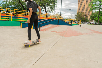 Fototapeta na wymiar Latina teen woman rollerblading in an outdoor park in Managua, Nicaragua