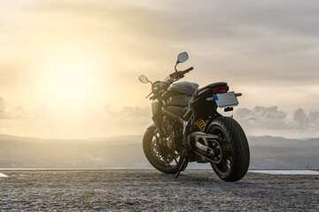 Motorcycle parked in front of the sunset