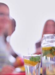 Top view of group of people having dinner together while sitting at wooden table. Food on the table. People eat fast food.
