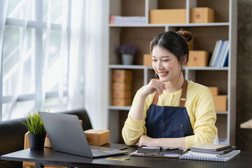 Small Business Startup SME Owners Asian Women Also Check Online Orders Laptops and sales of work items with girl boxes. Work independently at home, online SME business, small and medium enterprises