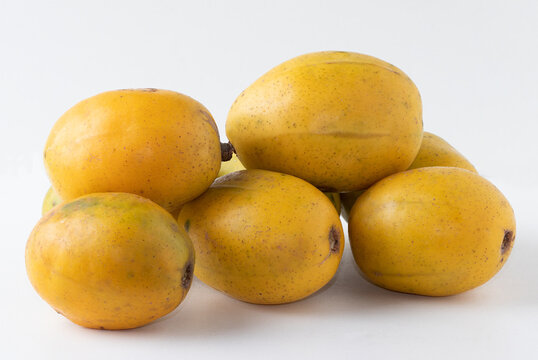 Portion of ripe June plum (spondias dulcis) isolated on white background.