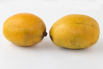 Ripe June plum isolated on white background.