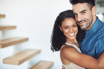 Obraz premium Hugging, love and affection couple loving, happy and smiling. Interracial boyfriend and girlfriend bonding together, dating and feeling positive. Portrait of cheerful married man and woman embracing