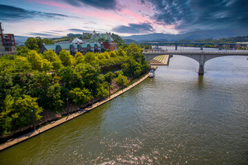 an aerial shot of a gorgeous summer landscape along the Tennessee River with bridges, buildings and...