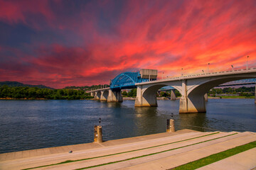 a gorgeous summer landscape on the Tennessee River with the Chief John Ross Bridge over the water...