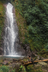 woman contemplating a waterfall in the middle of the cloud forest